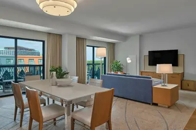 a living room with a table and chairs and a couch at Walt Disney World Swan in Orlando