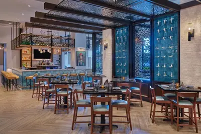 a restaurant with tables and chairs and a bar at Walt Disney World Swan in Orlando
