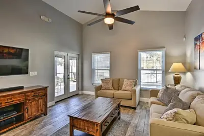 a living room with a couch and a ceiling fan at Mickeys Landing - Luxurious 4BR with 2 Master Suites, Privacy Fenced Pool & Hot Tub BBQ Game RM 2 miles to Disney! in Orlando