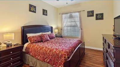 a bedroom with a bed and a dresser and a window at Executive 3 Bedroom Villa at Universal,Convention Center, Vista Cay in Orlando
