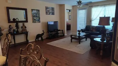 a living room with a couch and a tv at Executive 3 Bedroom Villa at Universal,Convention Center, Vista Cay in Orlando