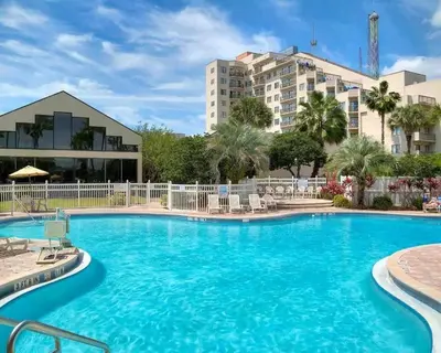 a swimming pool at a resort with blue water at Enclave Apartments at International Drive in Orlando