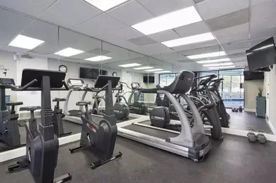a gym with treadmills and elliptical machines at Enclave Apartments at International Drive in Orlando