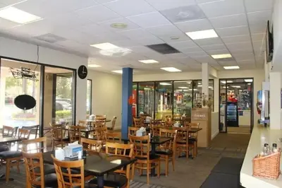 a dining room with wooden tables and chairs at Enclave Apartments at International Drive in Orlando