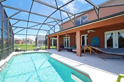 a house with a swimming pool with a glass roof at Aquamarine Hideaway in Kissimmee