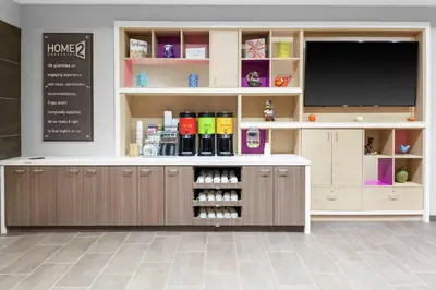 a pharmacyacist with a flat screen television in a room at Home2 Suites By Hilton Orlando South Park - Near Epic Universe in Orlando
