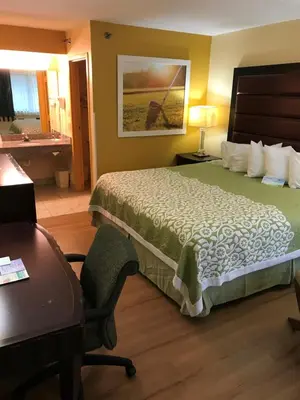 a hotel room with a bed and a desk at Days Inn by Wyndham N Orlando/Casselberry in Orlando