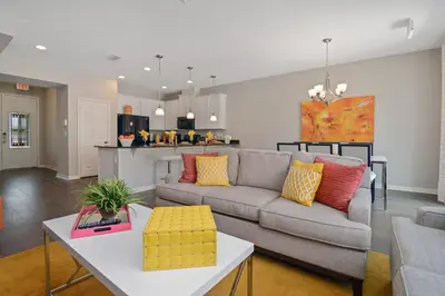a living room with a couch and a table at 4Bd Sleeps 9 w Jacuzzi Close to Disney @ Compass Bay 5113C in Kissimmee