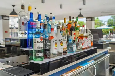 a counter with many bottles of alcohol on it at Casa Lucia Lakeview Condo in Orlando