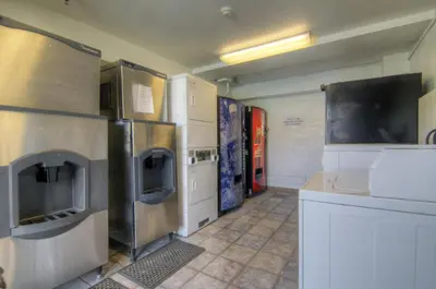 a kitchen with stainless steel appliances and white cabinets at Motel 6-Orlando, FL - Winter Park in Orlando