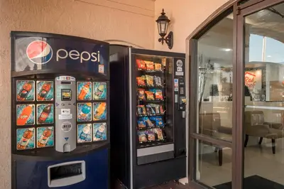 a pepsi vending machine next to a restaurant at Red Roof Inn Orlando South - Florida Mall in Orlando