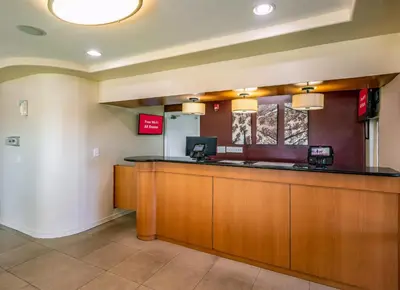 a lobby at a hospital with a reception counter at Red Roof Inn Orlando South - Florida Mall in Orlando