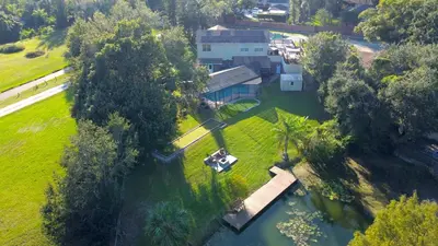 an aerial view of a house in the middle of a river at Lakefront 7 Bedroom Duplex, Pool, Boat, and Hottub in Orlando