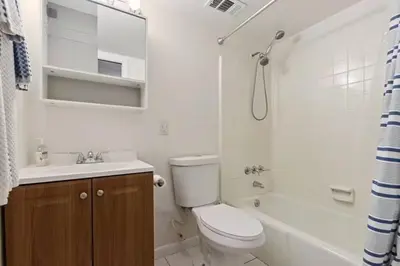 a bathroom with a toilet and a sink and a shower at Spacious Lakefront House with Pool, Hottub, & Boating in Orlando