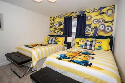 a bedroom with two beds with eyes on the wall at Four Bedrooms at StoreyLakeResort 3063 in Kissimmee