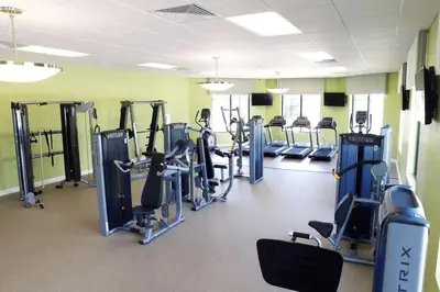 a gym with rows of tread machines in a room at Five Bedrooms Single Family 4759 in Kissimmee