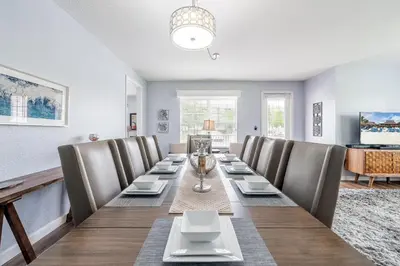 a long dining room with a long table and chairs at Cayview Avenue Unit 103 Condo in Orlando