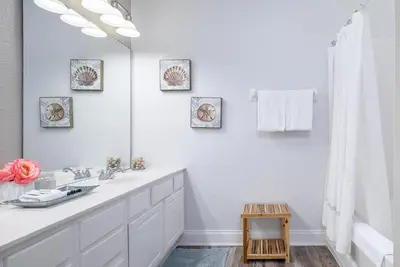 a white bathroom with a sink and a mirror at Tideview Circle Unit 38 Condo in Orlando
