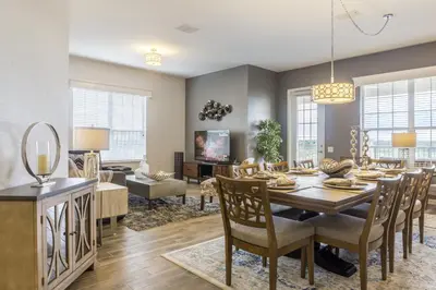 a dining room and living room with a table and chairs at Cayview Avenue Unit 404 Condo in Orlando