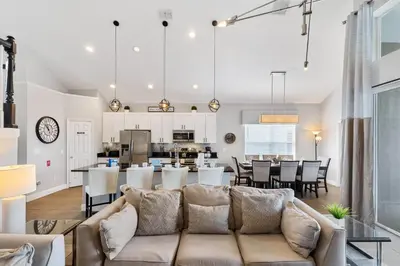 a living room with a couch and a dining room and kitchen at Sun Palm 8119 in Kissimmee