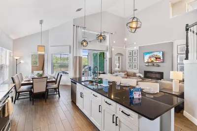 a kitchen and living room with a table and chairs at Sun Palm 8119 in Kissimmee