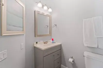 a bathroom with a sink and a mirror and a toilet at Sun Palm 8119 in Kissimmee