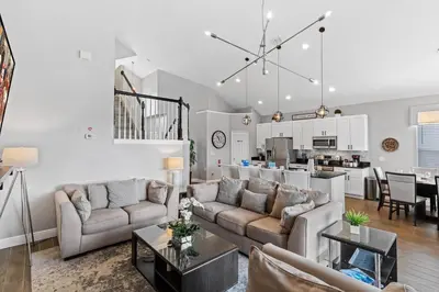 a living room with two couches and a kitchen at Sun Palm 8119 in Kissimmee
