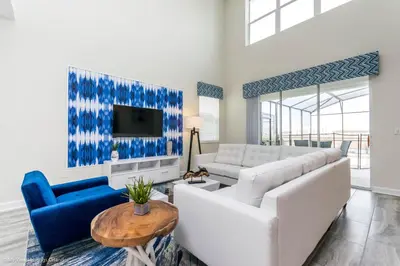 a living room with a white couch and blue chairs at Beautiful Home wPrivate Pool & Spa, near WDW in Kissimmee