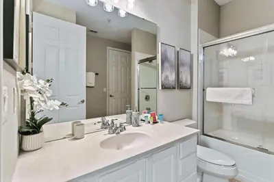 a bathroom with a sink and a toilet and a mirror at 4804 Cayview Ave #105 in Orlando