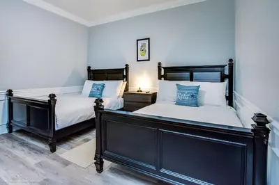 two twin beds in a bedroom with blue walls at Beautiful Condo w Private Balcony Near Universal in Orlando
