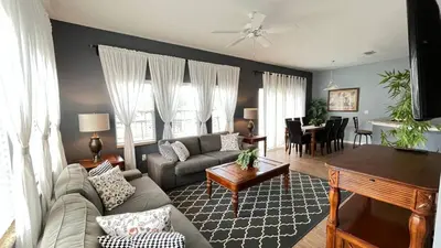 a living room with a couch and a table at Your Oasis Awaits! Indulge at Florida Hideaways 4BD Pool Home in Kissimmee