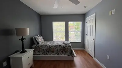 a bedroom with a bed and a window at Your Oasis Awaits! Indulge at Florida Hideaways 4BD Pool Home in Kissimmee
