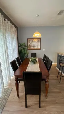 a dining room with a wooden table and chairs at Your Oasis Awaits! Indulge at Florida Hideaways 4BD Pool Home in Kissimmee