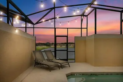 a patio with two chairs and a swimming pool at 8937CP-SVH in Kissimmee