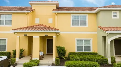 a yellow house with a red roof at 8937CP-SVH in Kissimmee