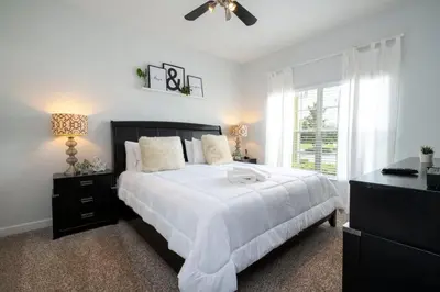 a bedroom with a white bed and a window at 8937CP-SVH in Kissimmee