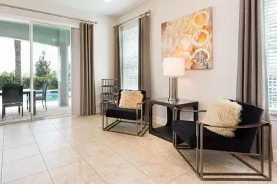 a living room with chairs and a table at Private Pool And Game Room With Waterpark & Resort Access At Encore Resorts Reunion - 141La in Kissimmee