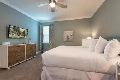 a bedroom with a white bed and a ceiling fan at Exquisite Home With Theater, Themed Rooms Near Disney With Waterpark & Resort Access At Encore Resort- 7664Ff in Kissimmee