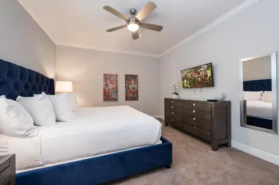 a bedroom with a large bed and a ceiling fan at Exquisite Home With Theater, Themed Rooms Near Disney With Waterpark & Resort Access At Encore Resort- 7664Ff in Kissimmee