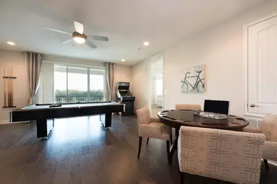 a living room with a pool table and a dining room at Exquisite Home With Theater, Themed Rooms Near Disney With Waterpark & Resort Access At Encore Resort- 7664Ff in Kissimmee