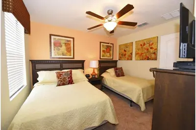 a bedroom with two beds and a ceiling fan at Holiday Villas of Kissimmee in Kissimmee