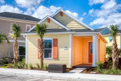 a house with palm trees in front of it at Margaritaville Cottages Orlando by Rentyl with H2O Waterpark in Kissimmee