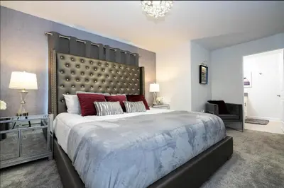 a large bedroom with a large bed with red pillows at Storey Lake Resort Just 5 Minutes to Mickey Mouse in Kissimmee