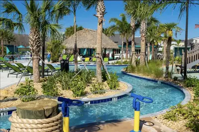 a pool at a resort with palm trees at Storey Lake Resort Just 5 Minutes to Mickey Mouse in Kissimmee