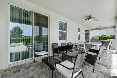 a dining room with a table and chairs at Striking Home With Games, Outdoor Kitchen Near Disney With Waterpark & Resort Access At Encore Resort - 7742Ff in Kissimmee