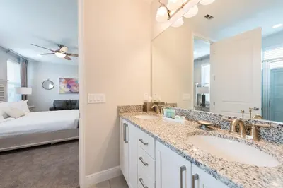 a bathroom with a sink and a mirror and a bed at Delightful Home Near Disney With Private Pool, Media Room, Waterpark & Resort Access At Encore Resort Reunion - 7418Mr in Kissimmee