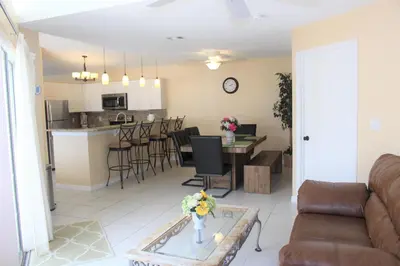 a living room and kitchen with a couch and a table at Crayson Villa LF811 in Kissimmee