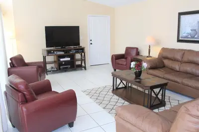 a living room with leather furniture and a flat screen tv at Crayson Villa LF811 in Kissimmee