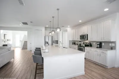 a kitchen with white cabinets and a white counter top at Sonoma Resort 7 Bedroom Home with Pool 1849 in Kissimmee