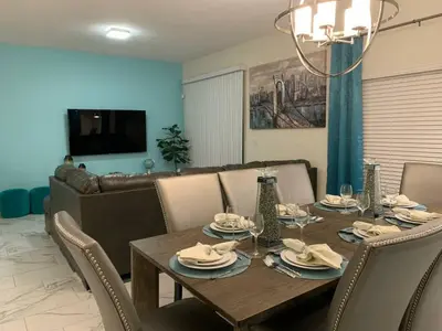 a dining room with a wooden table and chairs at DWS Vacation Villas in Orlando